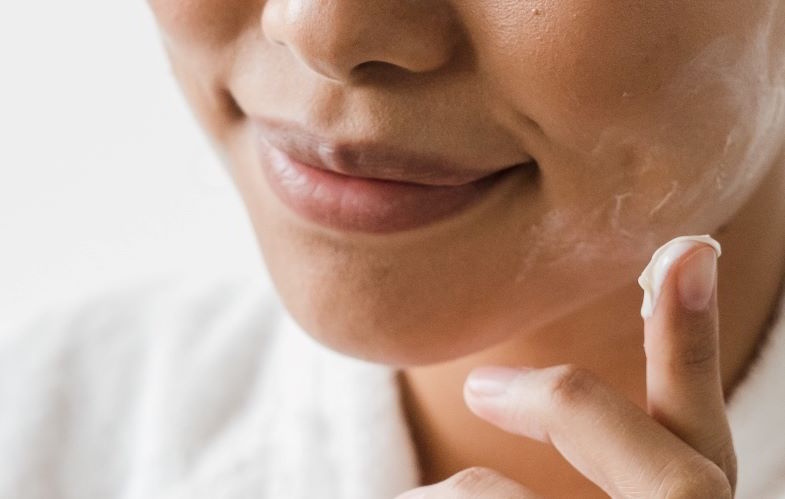 Woman using hemp face cream