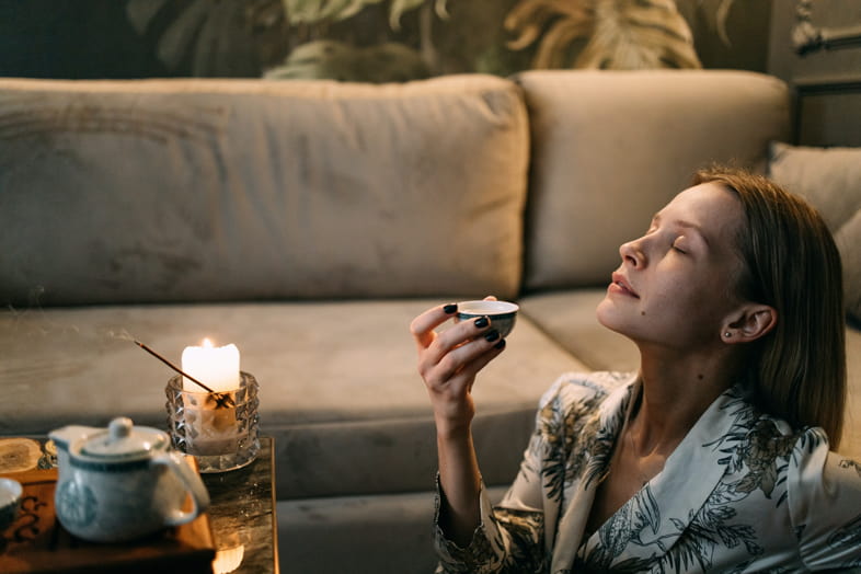 Girl drinking anti-stress herbal tea with full-spectrum CBD oil