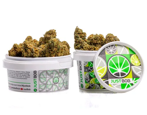 tin with flowers of orange cbd boost cannabis