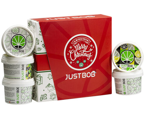 Justbob XMAS KIT open box with multiple containers of legal CBD flower, featuring Christmas branding and cannabis leaf design, perfect for holiday gifting