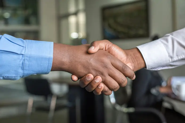 hands-shaking Two hands clasped together to symbolize a sales agreement | Justbob
