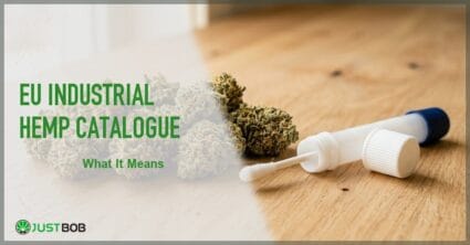 Justbob featured banner for EU Industrial Hemp Catalogue: hemp flower bud and open sample collection vial with white applicator on warm wood desk
