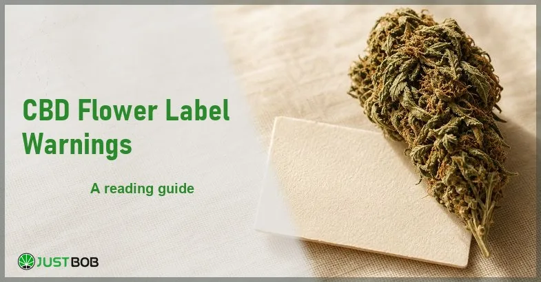 Justbob CBD Flower Label Warnings banner with green title, a hemp flower bud and a blank label card on cream linen