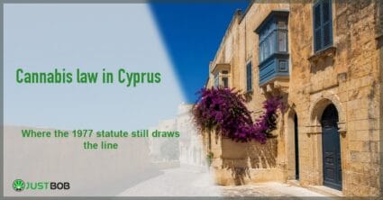 Justbob Cyprus cannabis law banner with green title beside a sunlit limestone street with bougainvillea