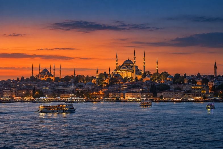 is-weed-legal-in-turkey-istanbul-skyline The Istanbul skyline at dusk with mosque domes and minarets silhouetted above the Bosphorus waterfront